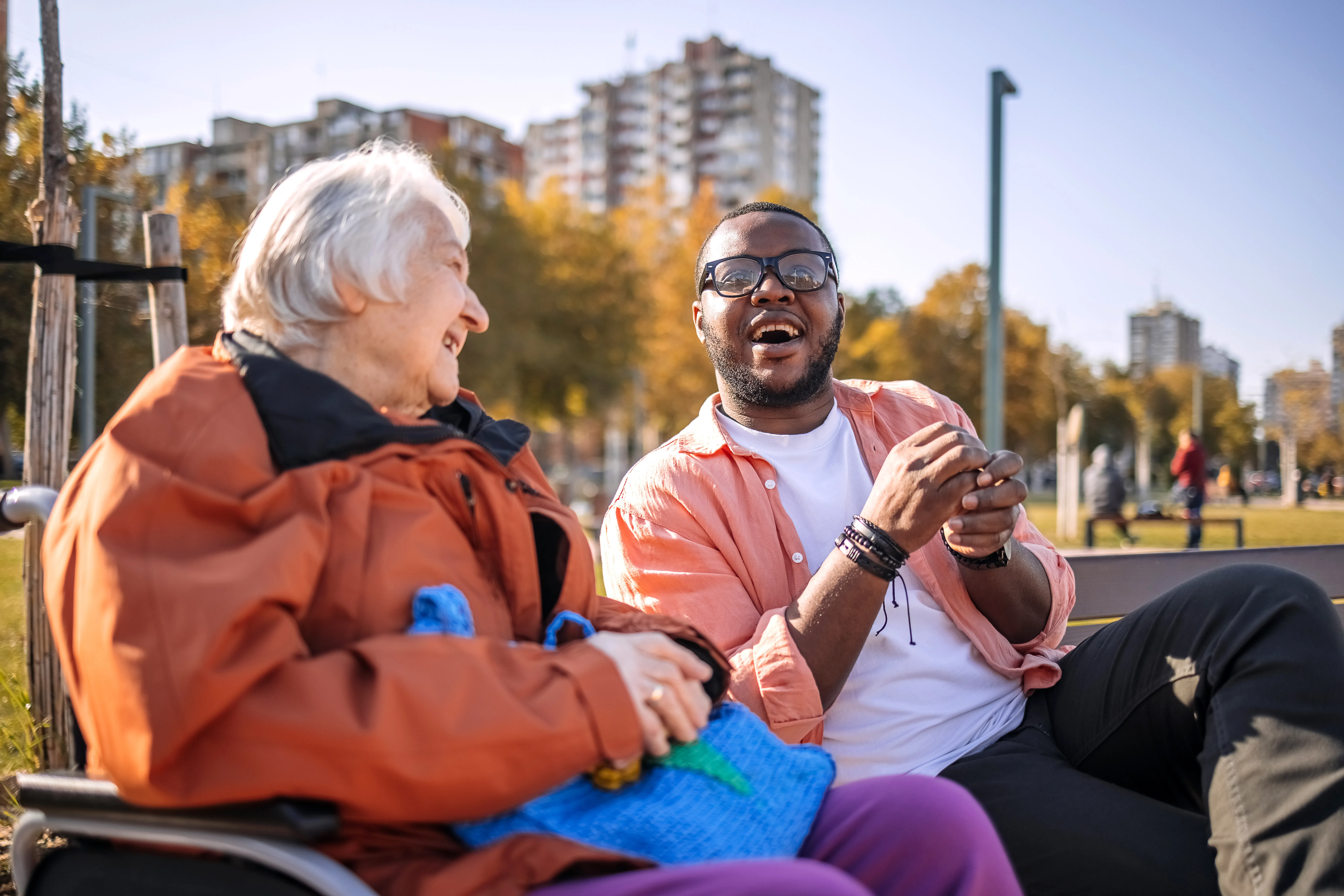 A compassionate carer sharing a meaningful moment with an elderly woman in her home.